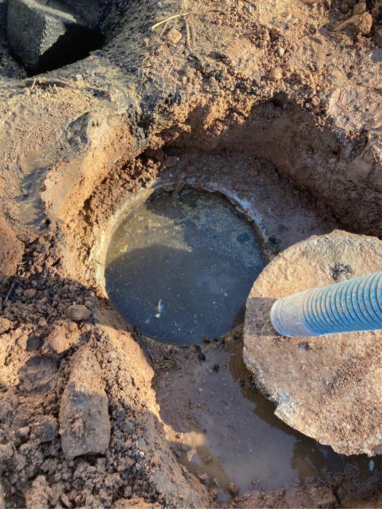 Technician pumping full septic tank