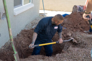 Justin with HomeField digging down to the septic tank lids